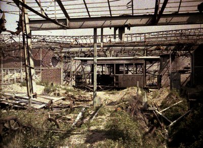 The Burned Out Railroad and Streetcar Yard with a Few Damaged Vehicles and a Locomotive, Soissons, Aisne, France, 1917 by Fernand Cuville